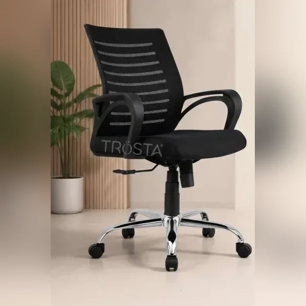 Compact black mesh computer chair at a study desk